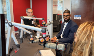 two men in a radio studio surrounded by microphones